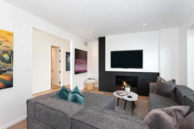 Pinewood living room with black brick fireplace and teal accents