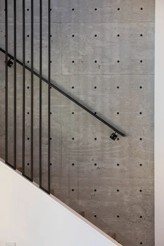 Pinewood staircase with wooden steps and black metal railing