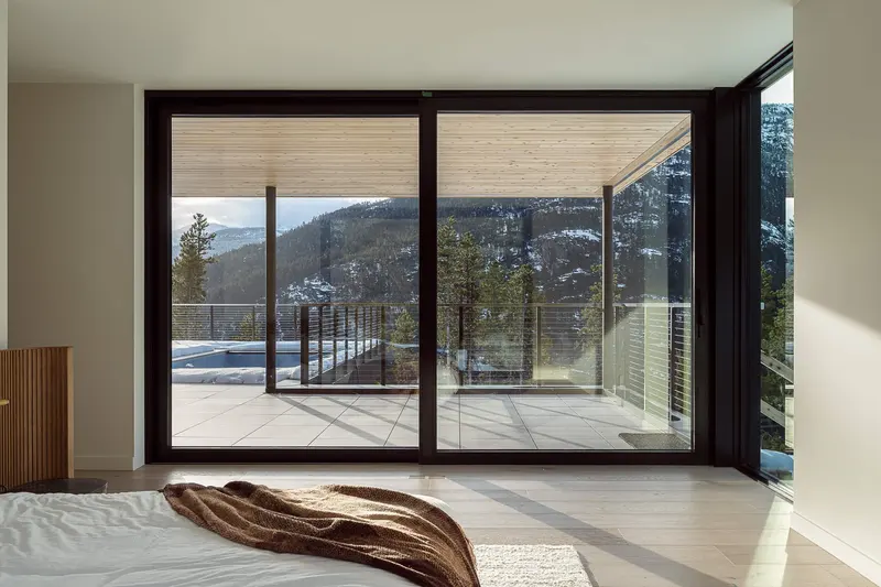 Warbler Way exterior material detail — metal meets cedar